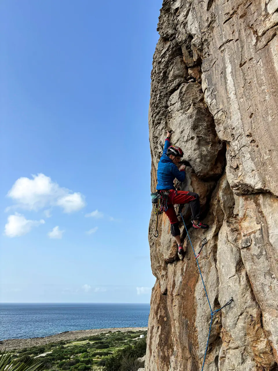 Roxi leading a limestone route above the sea